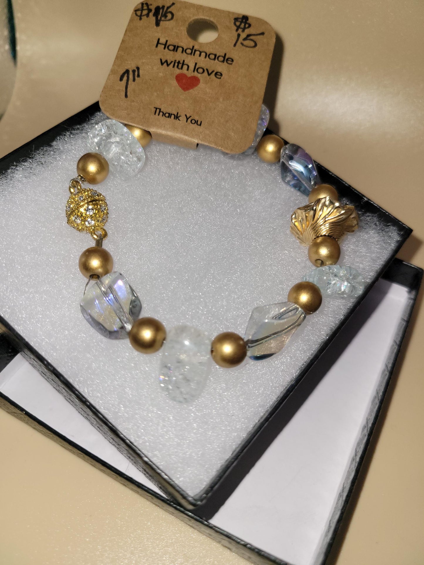 Hand crafted 7.0 in clear and gold colored bracelet