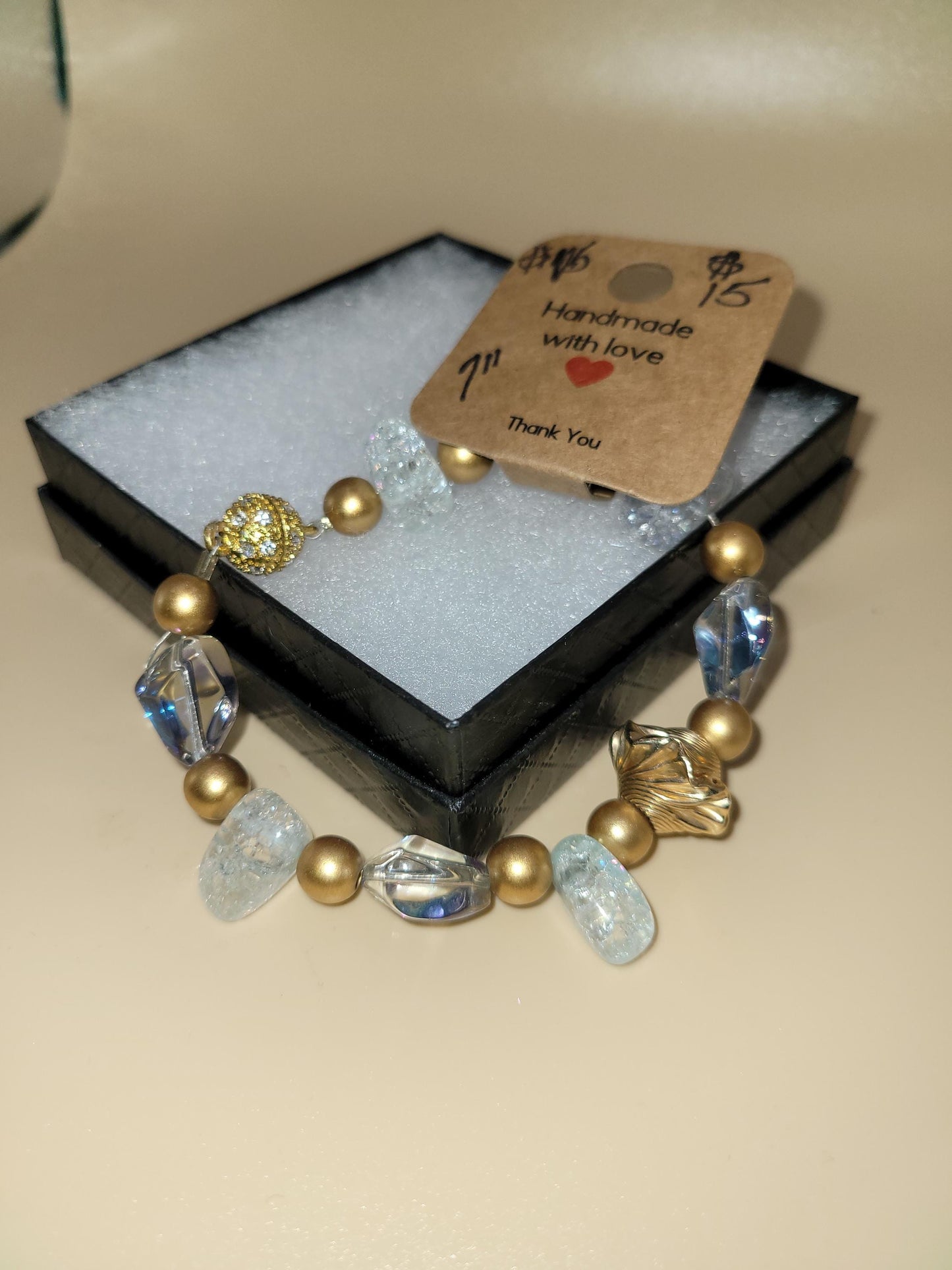 Hand crafted 7.0 in clear and gold colored bracelet