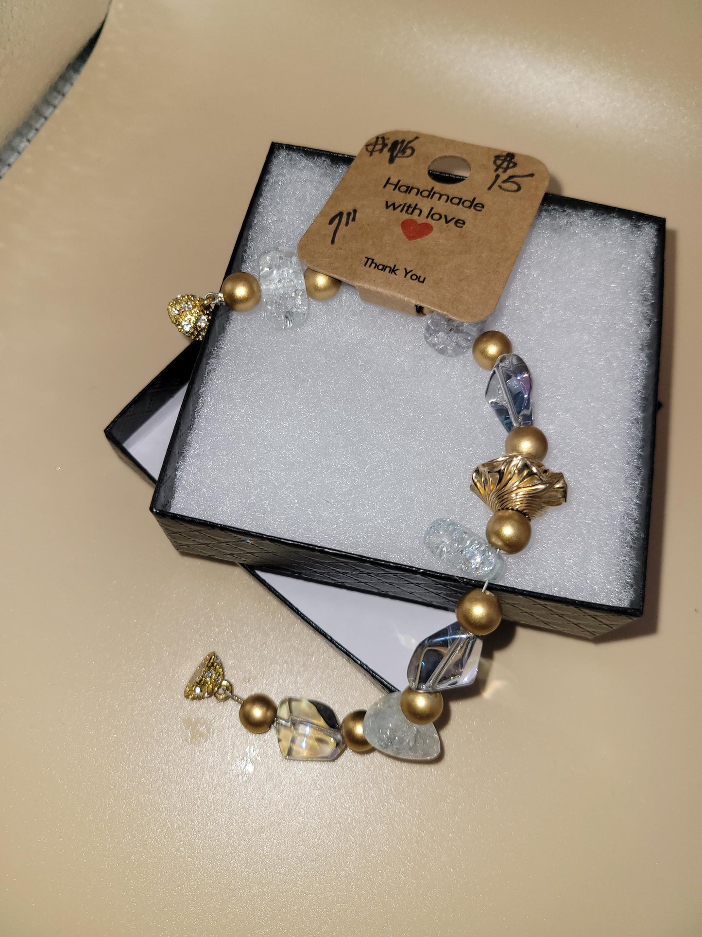 Hand crafted 7.0 in clear and gold colored bracelet